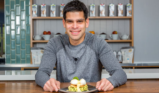 Image of man posing alongside the dish he has created