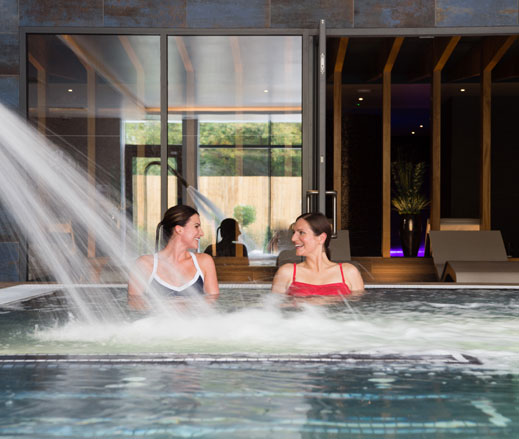 Image of two ladies relaxing in the hydro pool at David Lloyd Chigwell