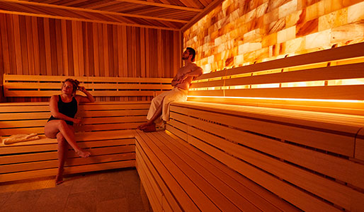 Man and lady sat in the sauna at David Lloyd Royal Berkshire